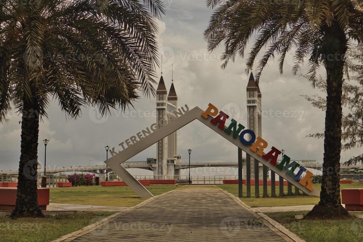 A stunning photogenic Kuala Terengganu drawbridge under a dramatic cloudy sky with structure featuring twin towers and a modern design that nestled against the ocean below. photo