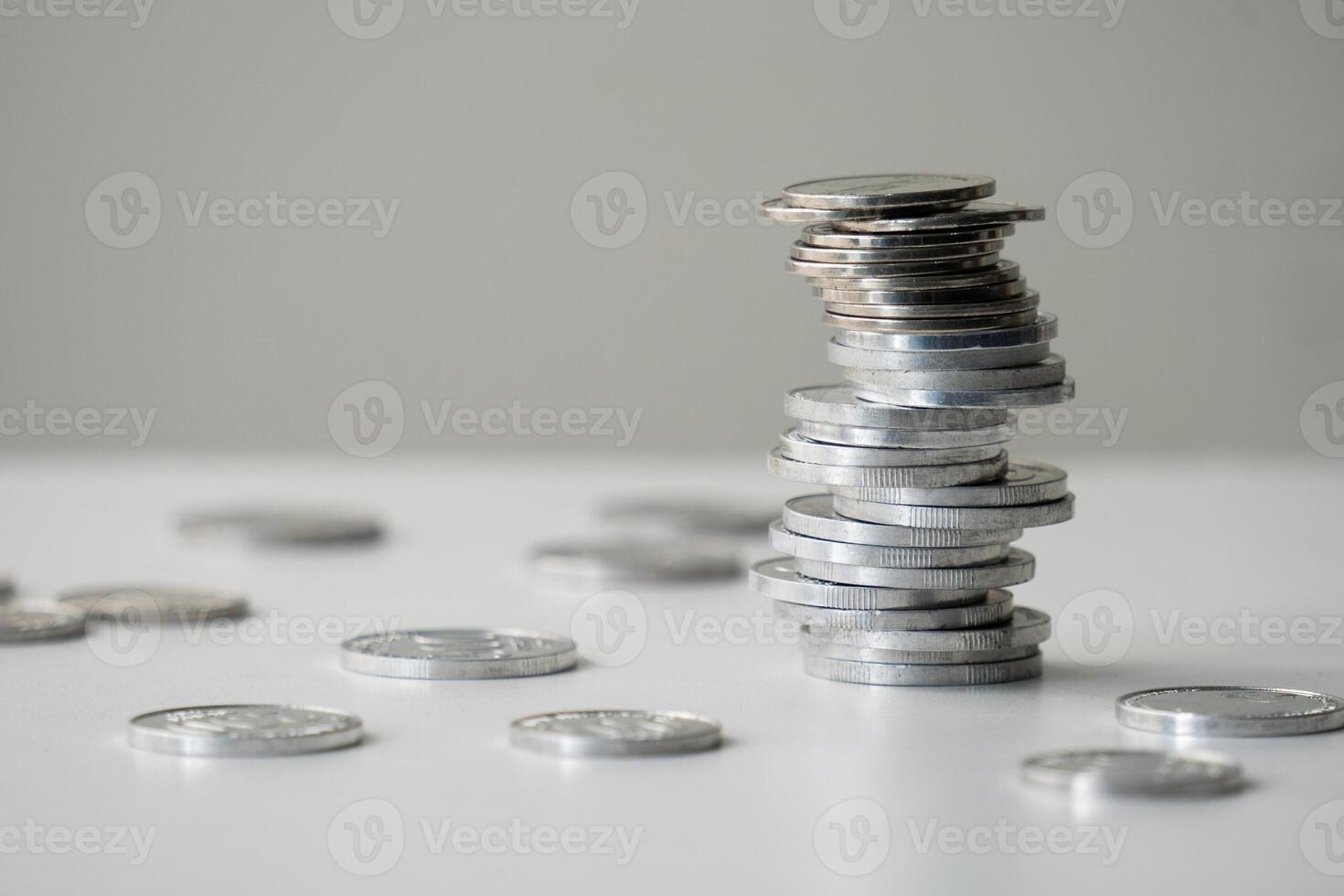 Currency coins are stacked irregularly on the table photo