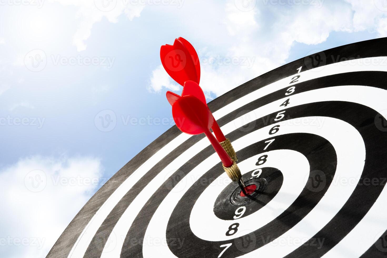 Two arrows on target board with sky background photo