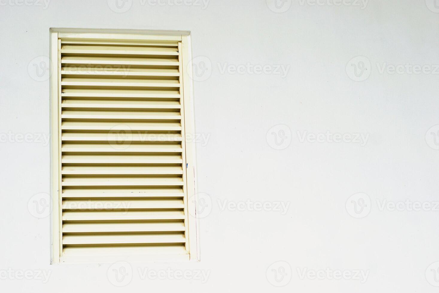 window with shutters on white wall with copy space photo
