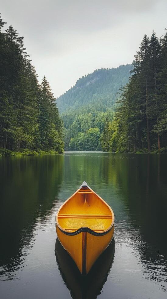 Canoeing on a peaceful lake surrounded by autumn trees under a cloudy sky photo