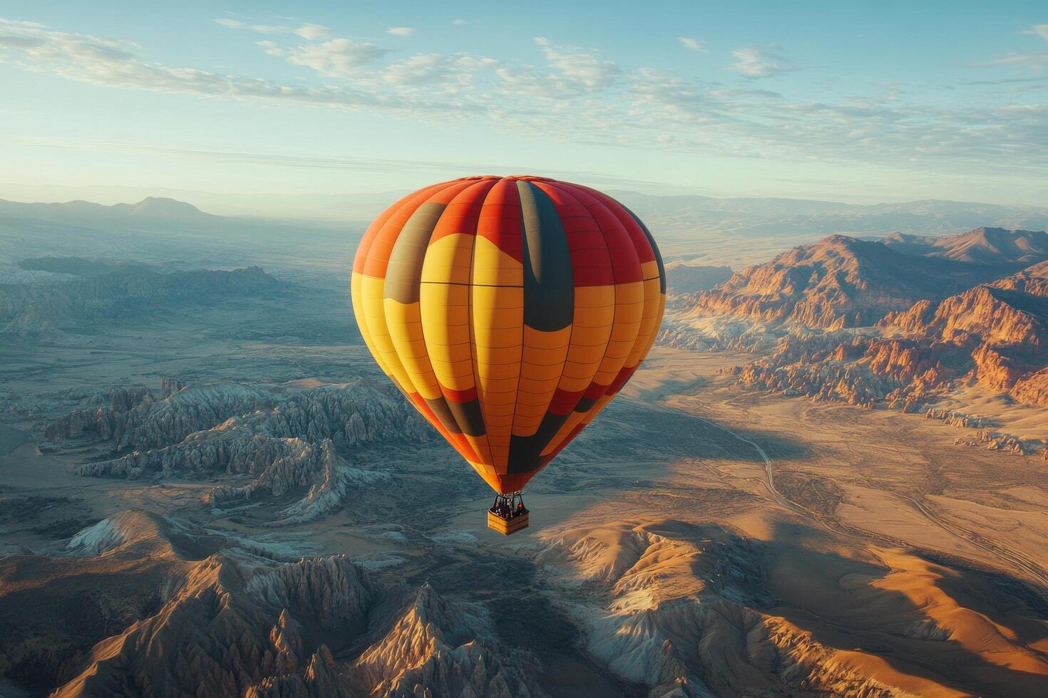 Hot air balloon soaring over rugged mountains under a beautiful sky at dusk photo