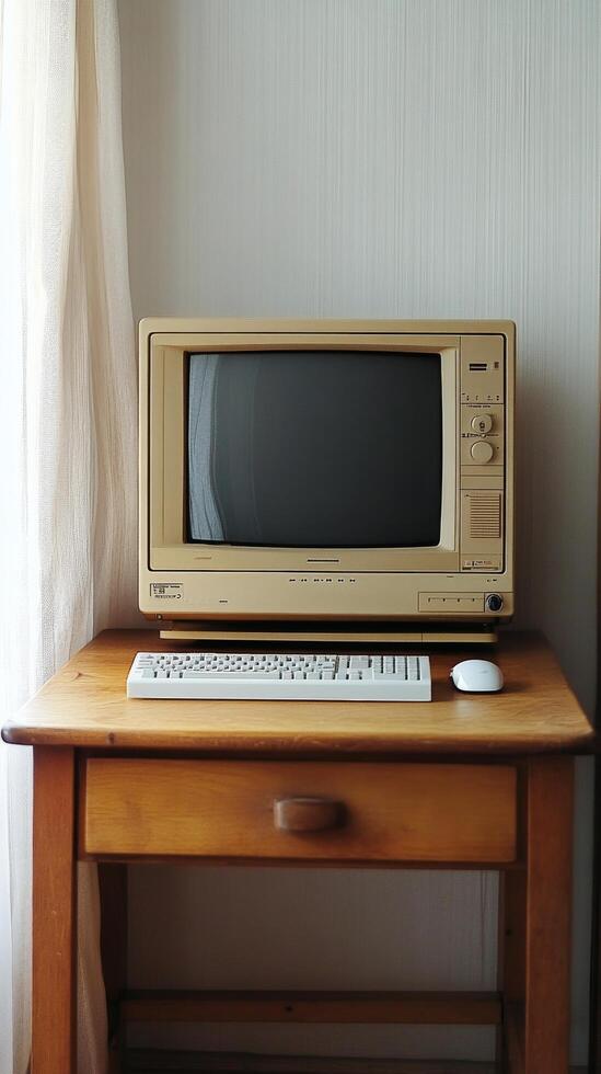 Vintage computer setup with monitor and keyboard on a wooden desk photo