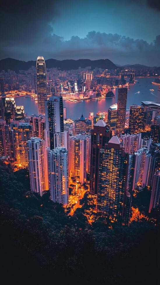 View of city skyline illuminated at sunset with mountains in the background photo