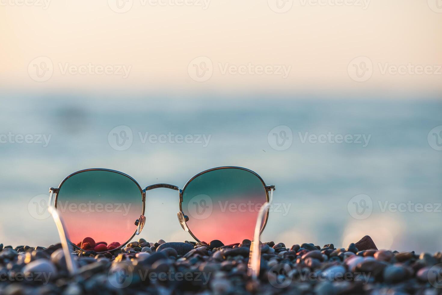 Colorful bright sunglasses on the background of the sea, concept summer vacation at the sea photo