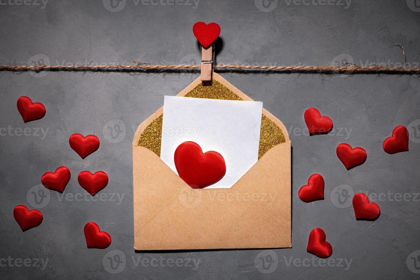 clothespins with red hearts on a rope on a gray background. Background for a postcard photo