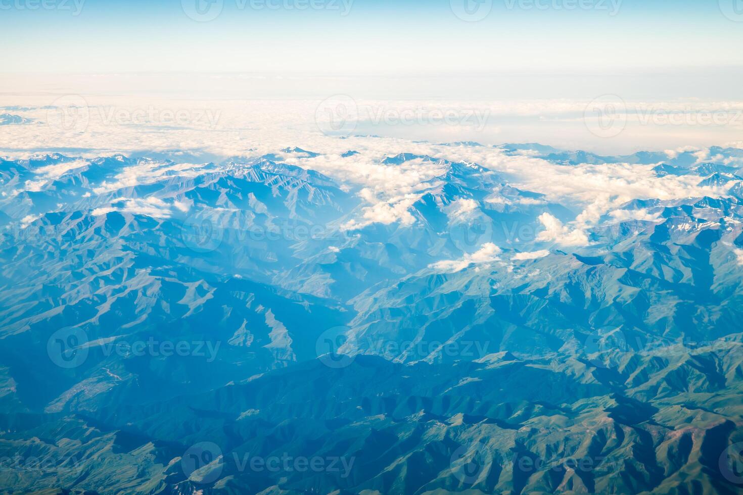 A view of the planet Earth, a view from an airplane, mountains and clouds photo