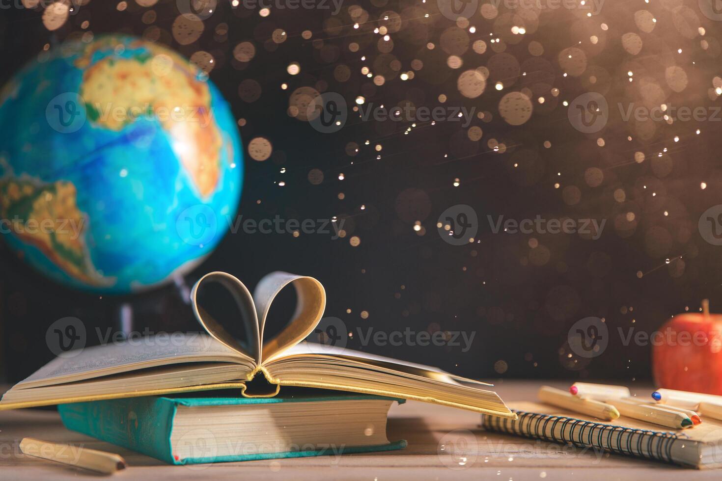 books, stationery on the table on a black chalkboard. Education, September 1, new academic year photo