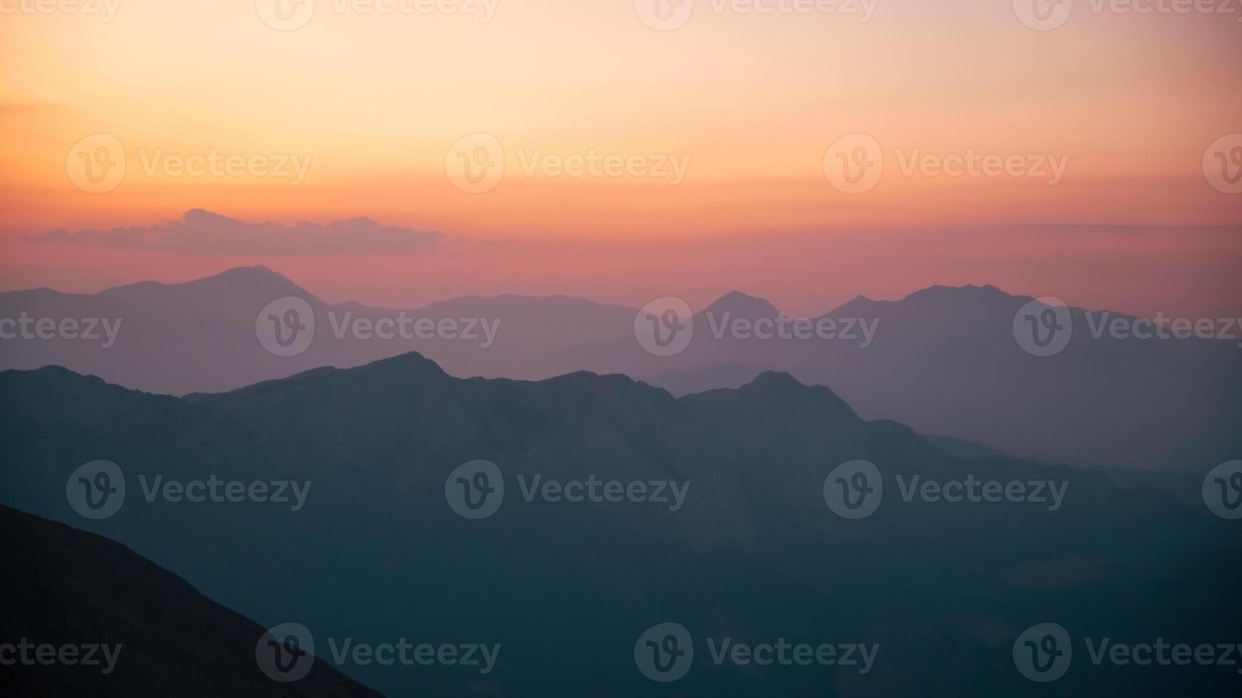 Silhouettes of mountains in a beautiful gentle haze, mountains at sunset or sunrise, natural background photo