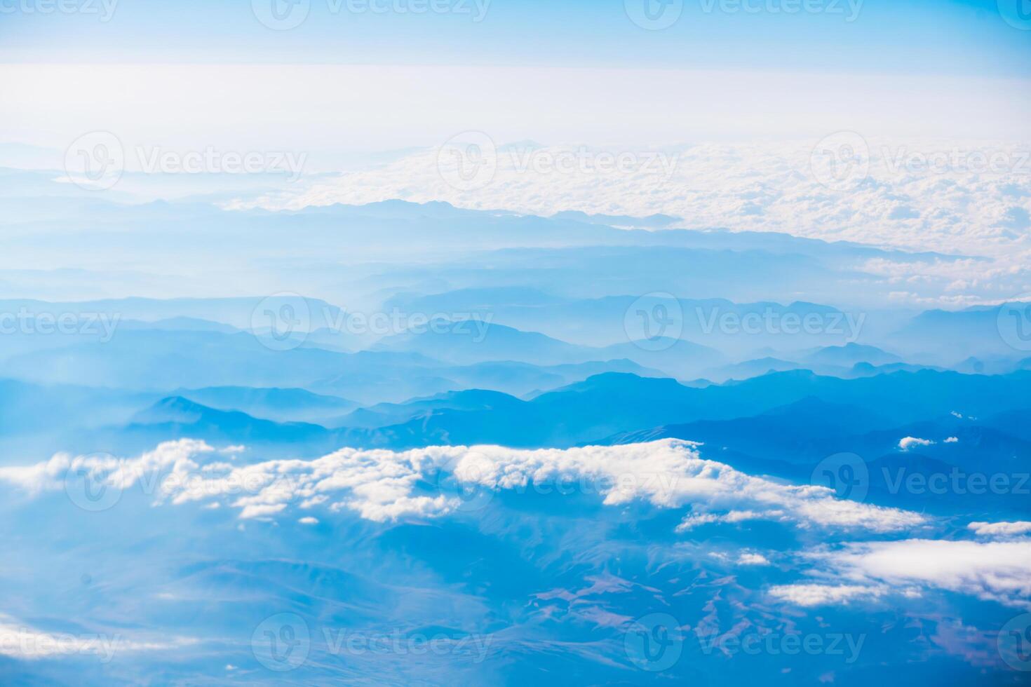 A view of the planet Earth, a view from an airplane, mountains and clouds photo