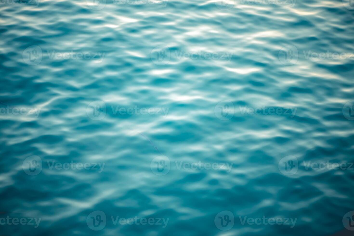 Water texture with waves and splashes from fish, natural natural water, sea background photo