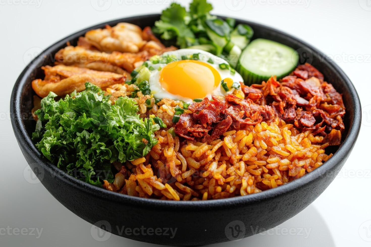 A Bowl of Fried Rice with Toppings like Fried Egg, Bacon, and Cucumber photo