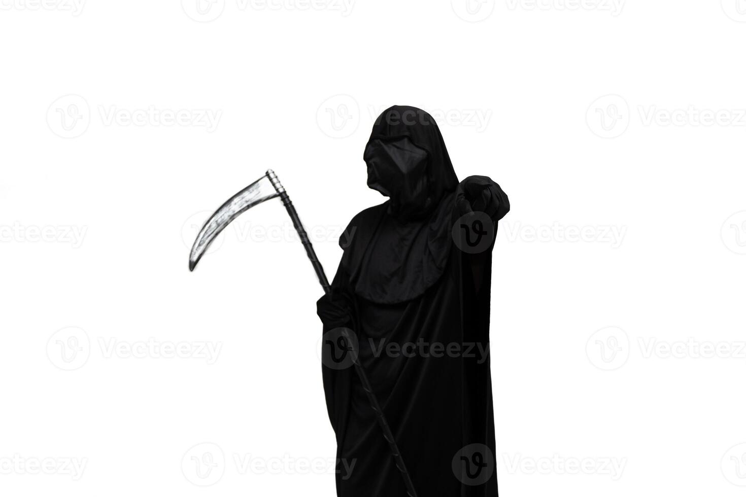 Grim reaper in Halloween costume holding scythe and pointing at the camera white background photo