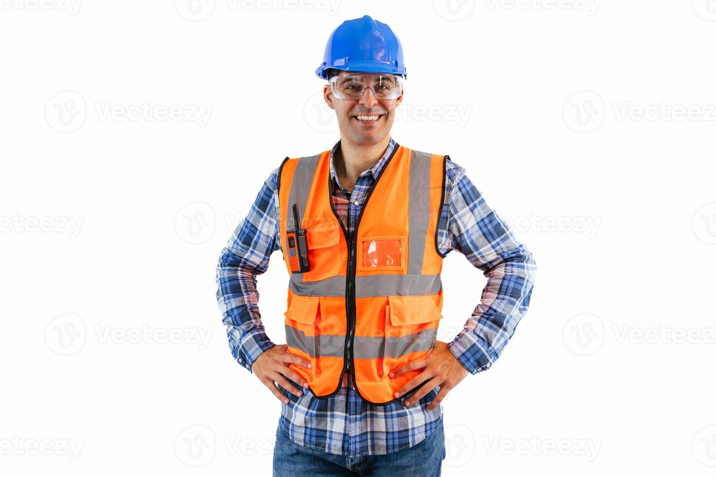 Engineer in blue helmet and orange safety vest smiling with hands on hips white background photo