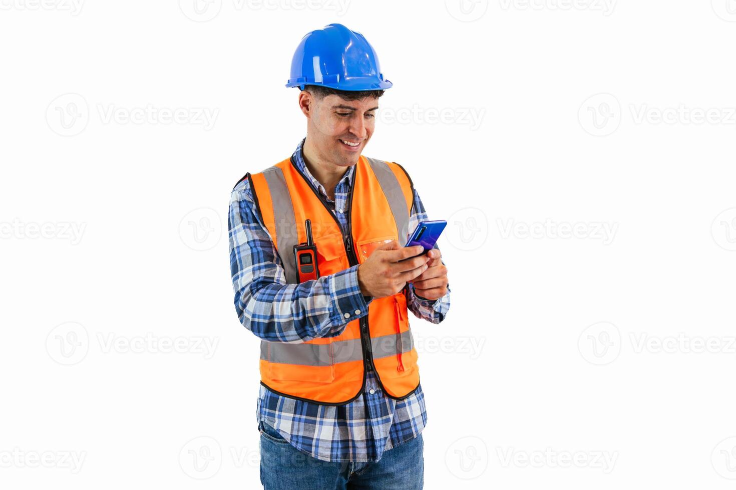 Engineer sending emails with smartphone wearing orange vest and safety helmet white background photo