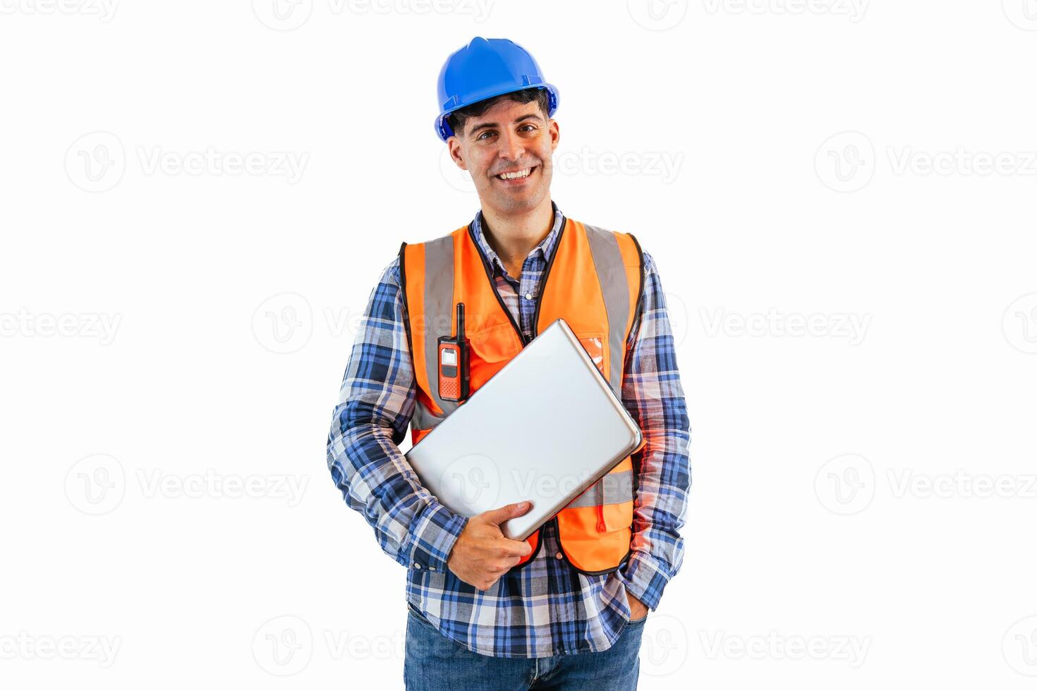 Engineer holding laptop and looking at camera wearing reflective orange vest and safety helmet photo
