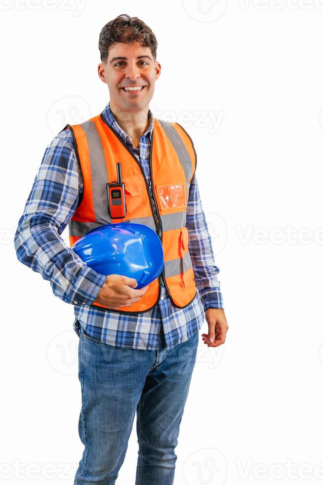 vertical Construction worker smiling at camera while holding safety helmet under arm photo