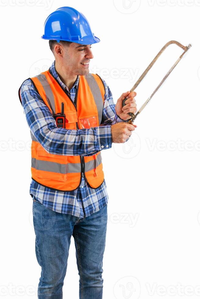 vertical Construction worker sawing material with a saw wearing orange vest and safety helmet photo