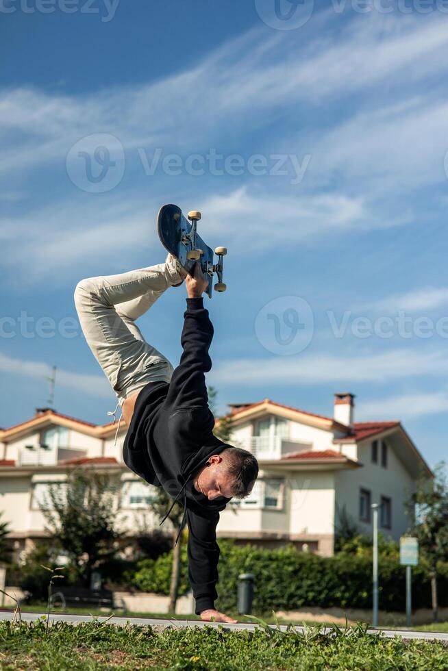vertical Skater executing an aerial maneuver on the edge of the skate park bowl photo