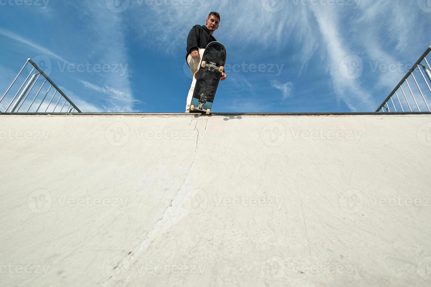 copyspace Fish-eye view of a skater looking impressive at the edge of the half pipe photo