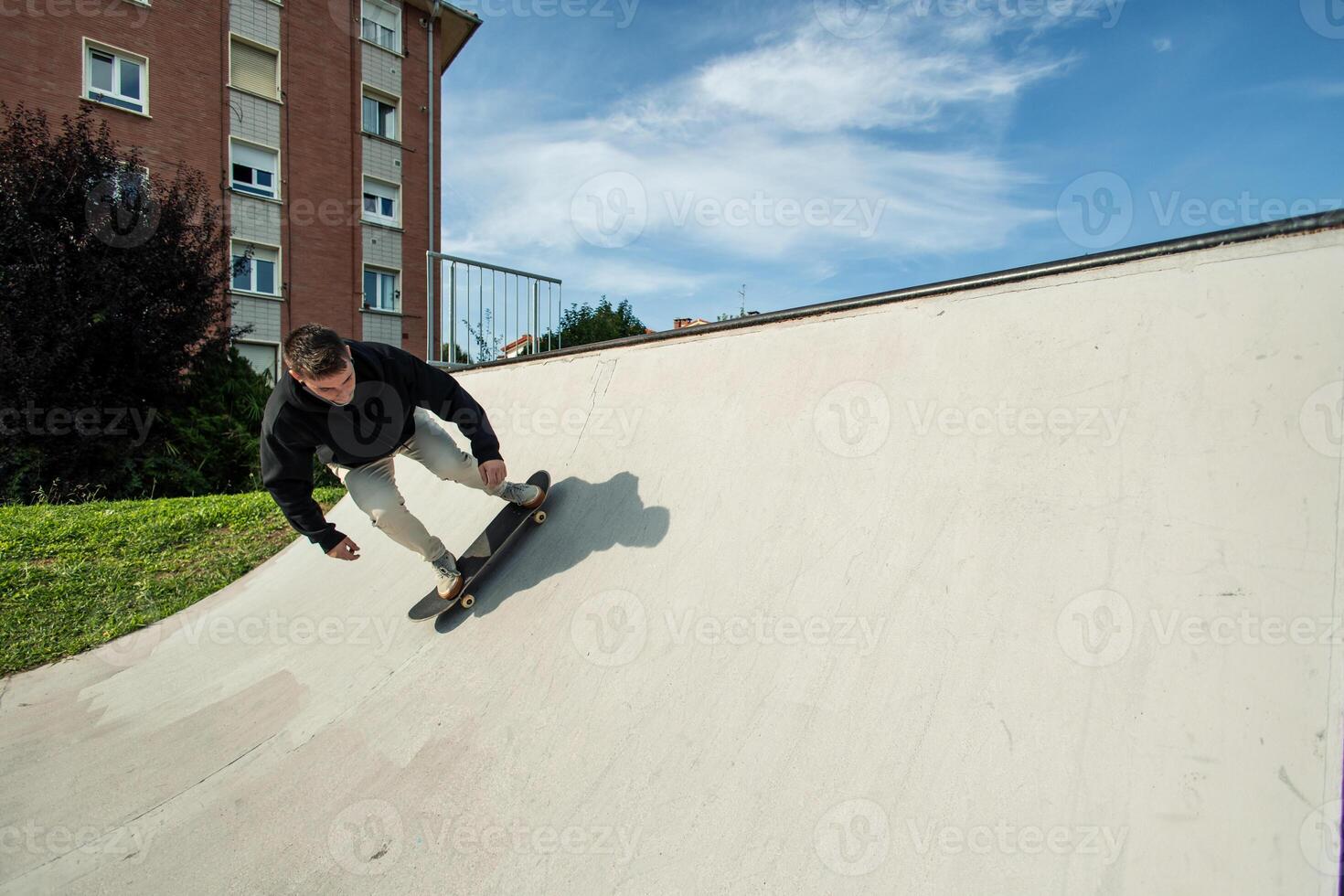 Fish-eye view of a skater launching off the half pipe photo