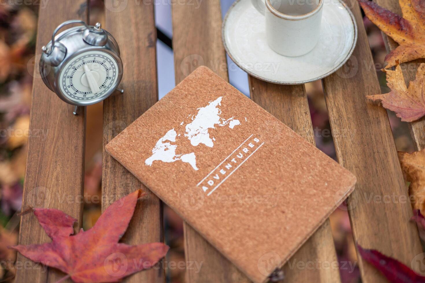 Planning adventures with notebook, coffee, and alarm clock in autumn photo