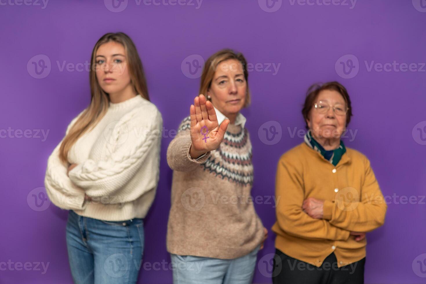 Three generations of women showing female symbol and claiming equality photo
