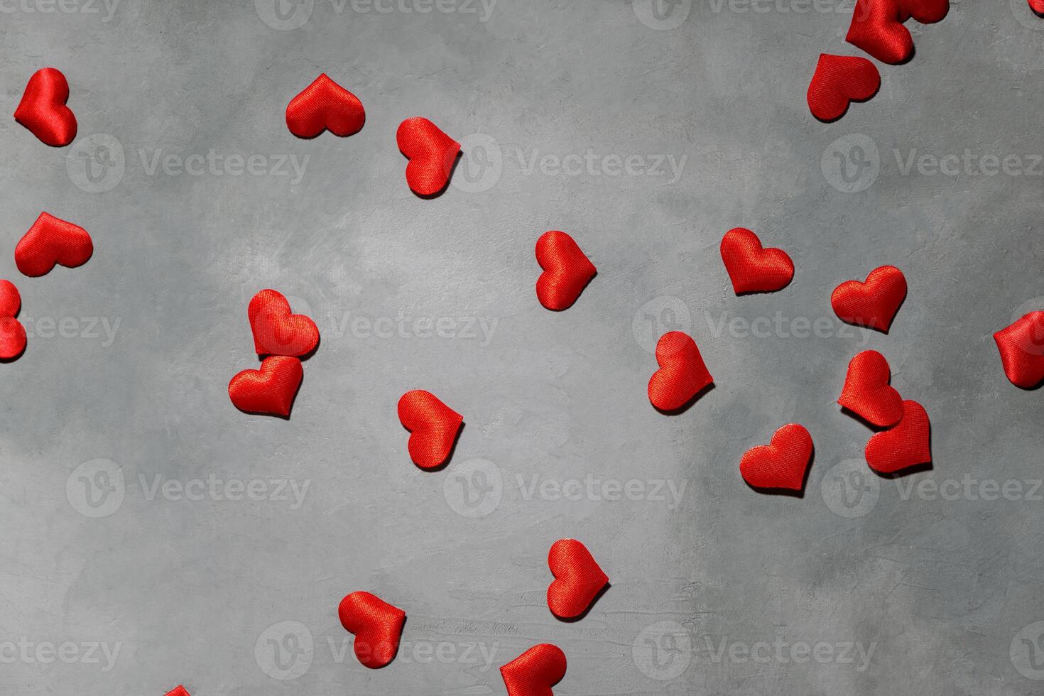 Red hearts on a gray background. Background for a postcard photo