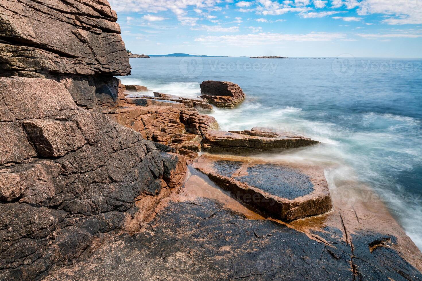 Walking through the forest and coast of Acadia national park in Maine on a sunny day photo