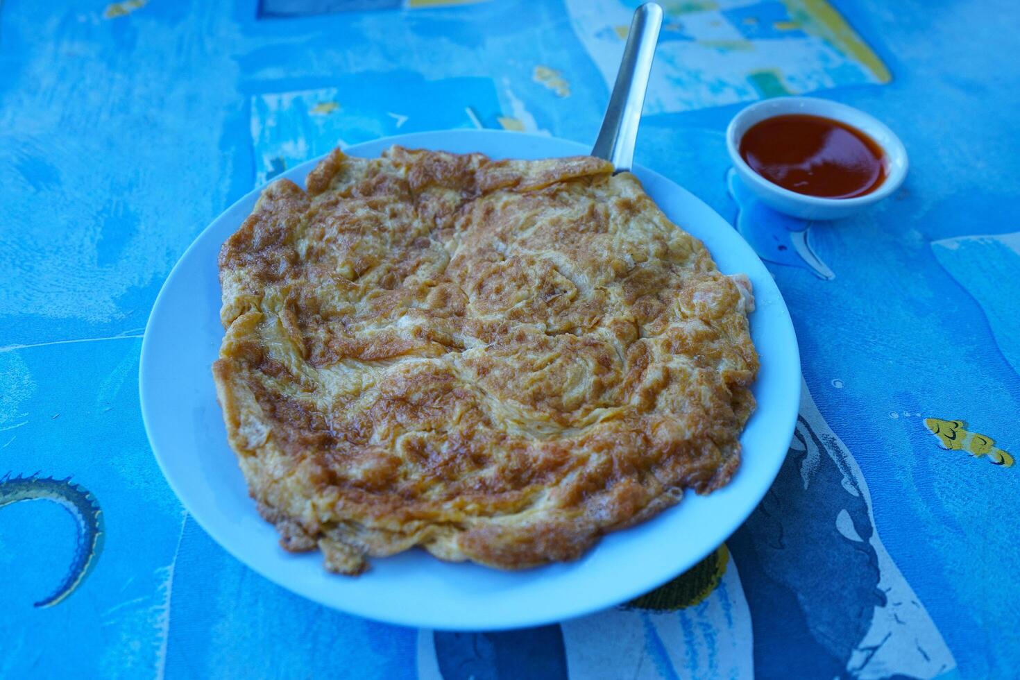 Close up Thai omelet with spicy sauce photo