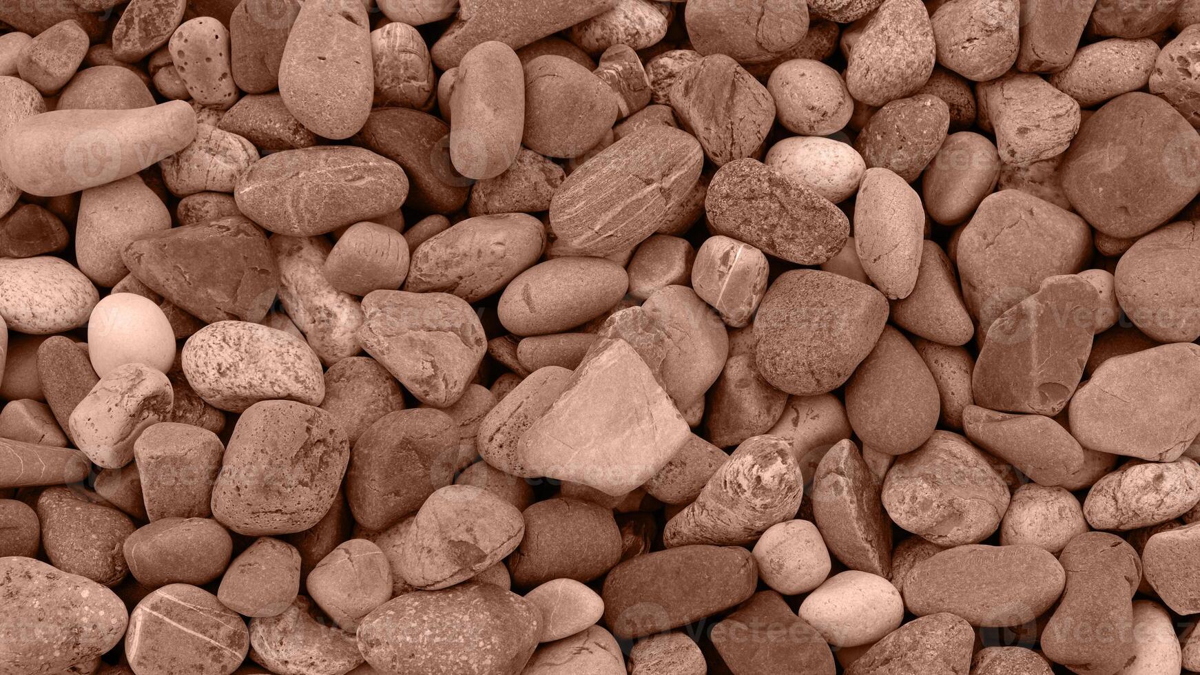 Background made of Sea or river pebbles. Natural texture of beach pebbles. Color Of The Year 2025 - Mocha Mousse photo