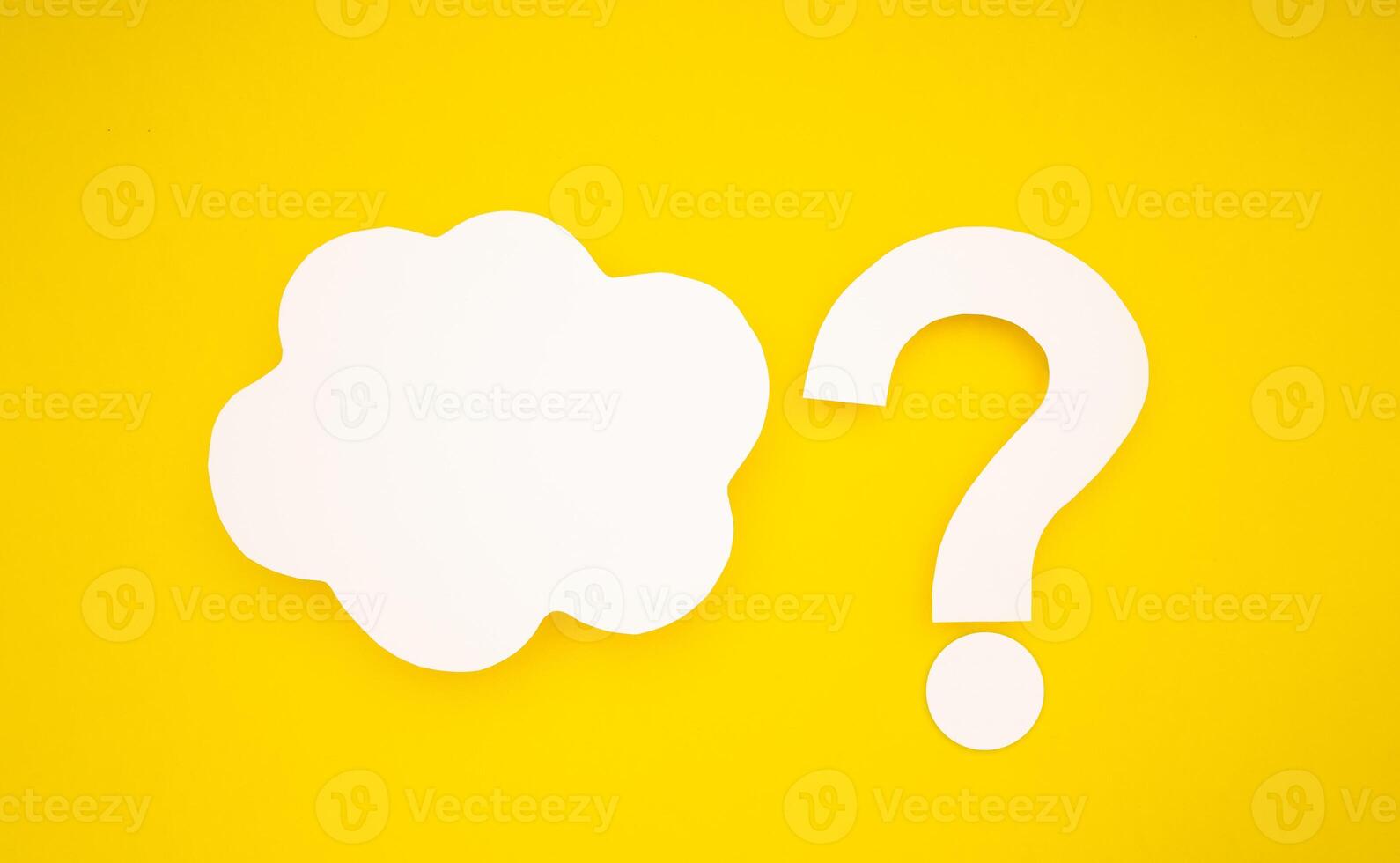 A white speech bubble cloud and question mark symbol are on a yellow background photo