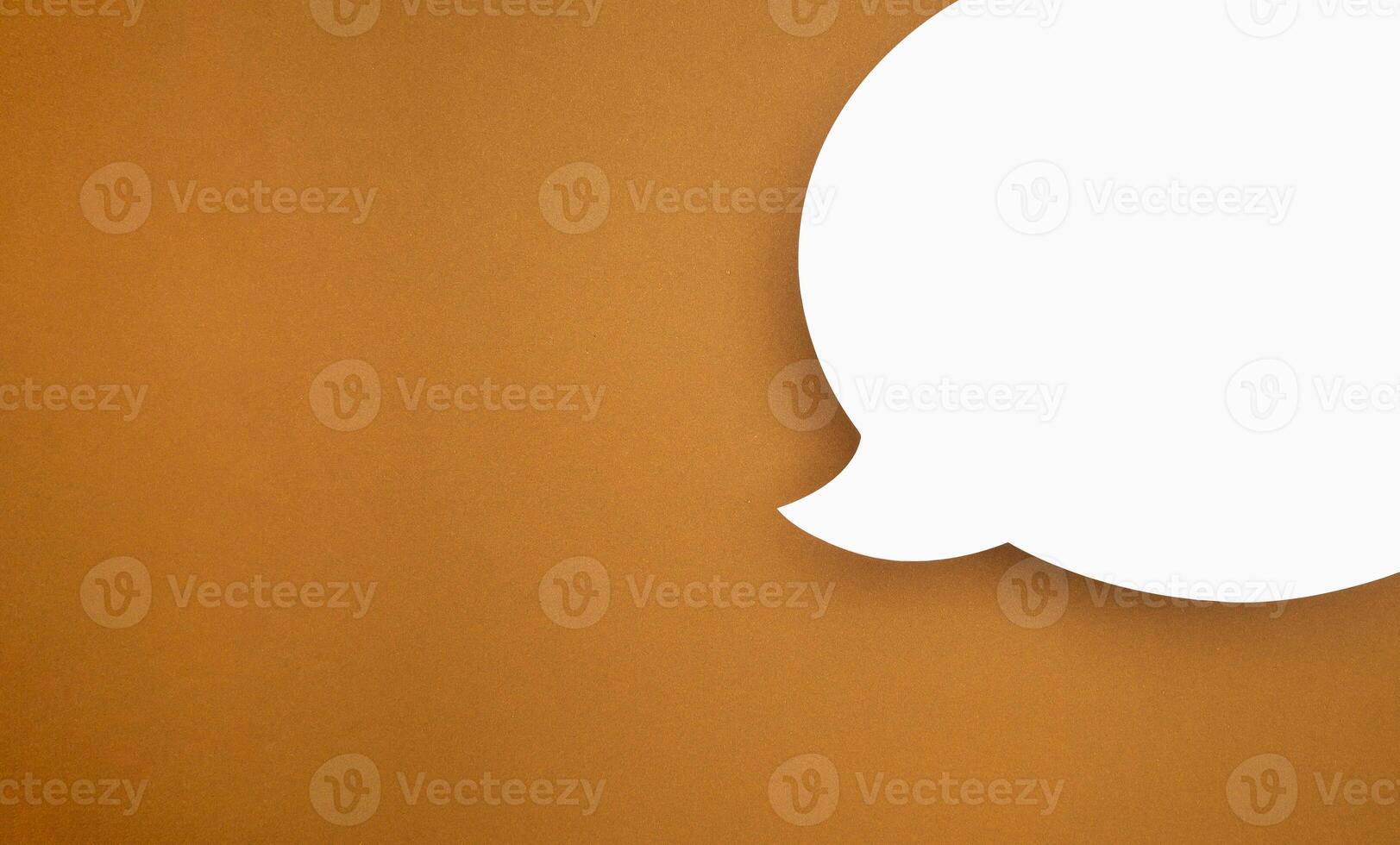 A blank white speech bubble part over a brown background photo
