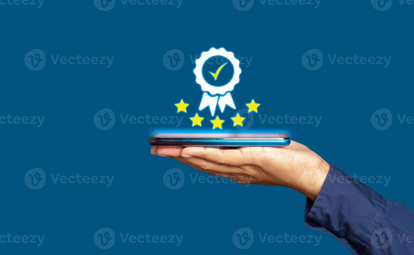 Close-up of a hand businessman holding a smartphone and showing the best quality assurance with five stars symbol photo