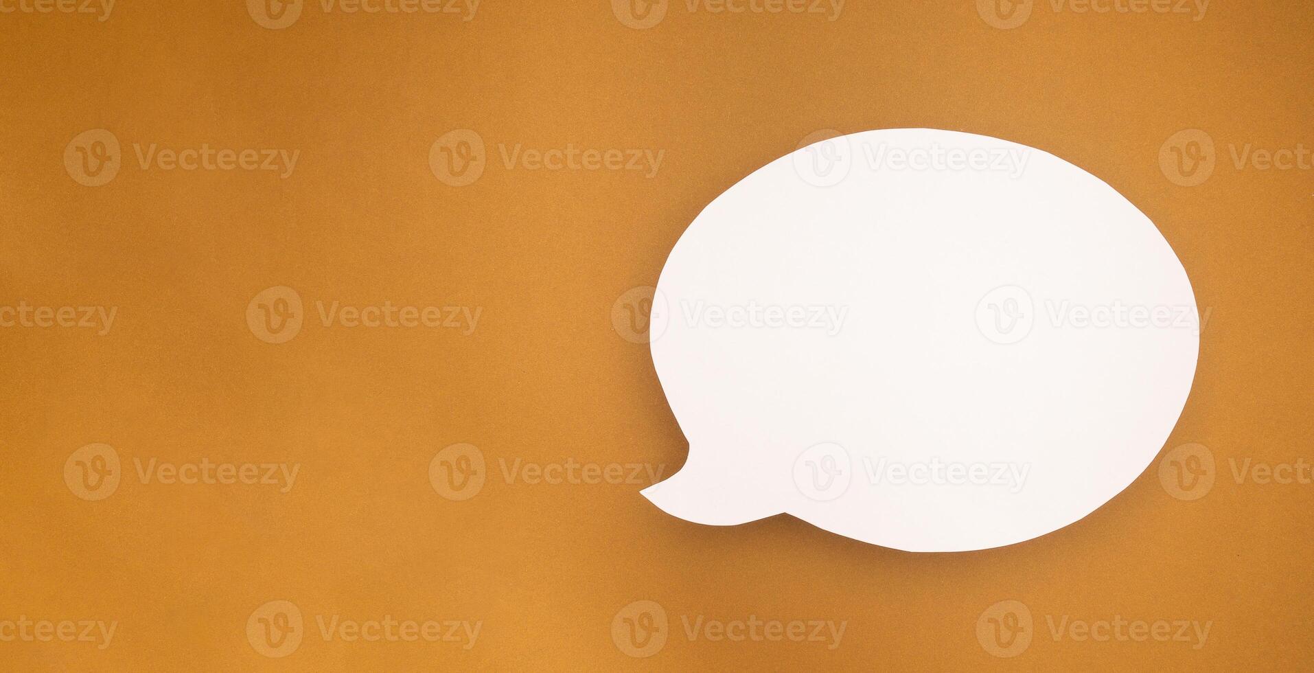 A blank white speech bubble over a brown background photo