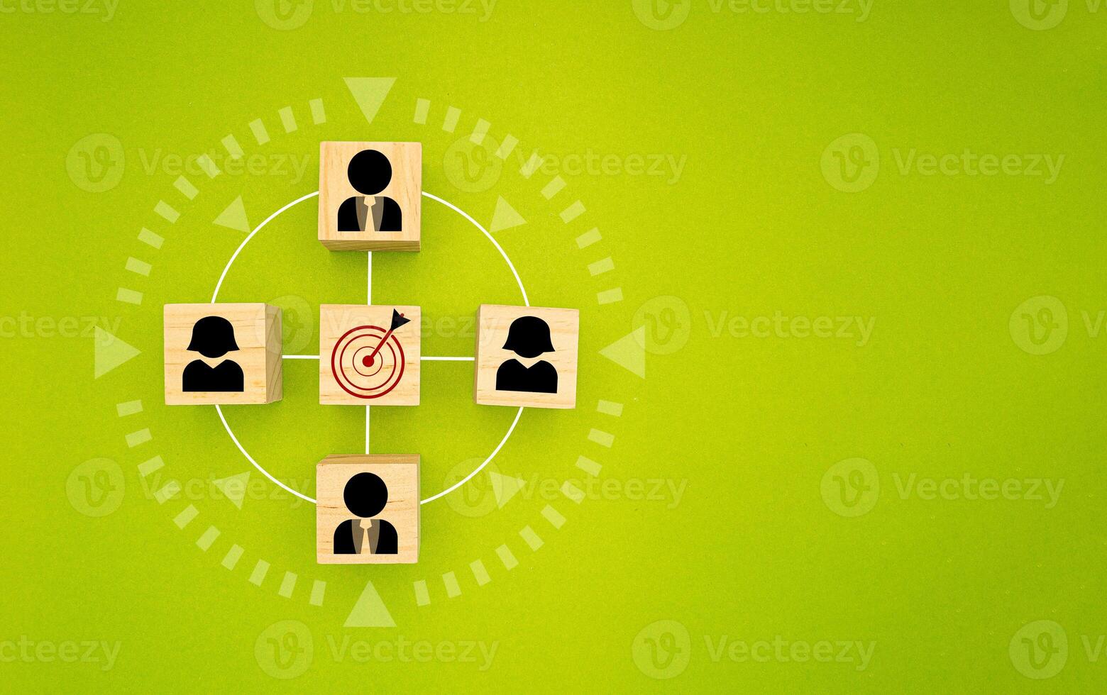 Wooden cubes with people icons focus on the goal over a green background photo