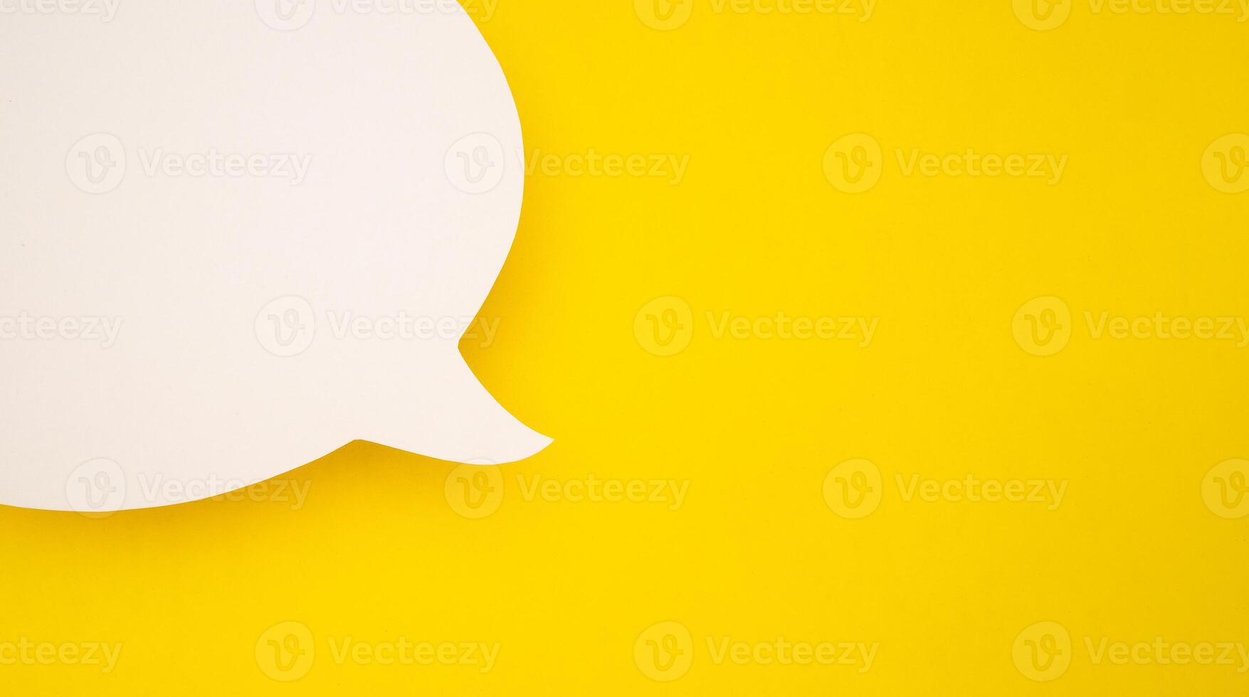 A blank white speech bubble part over a yellow background photo
