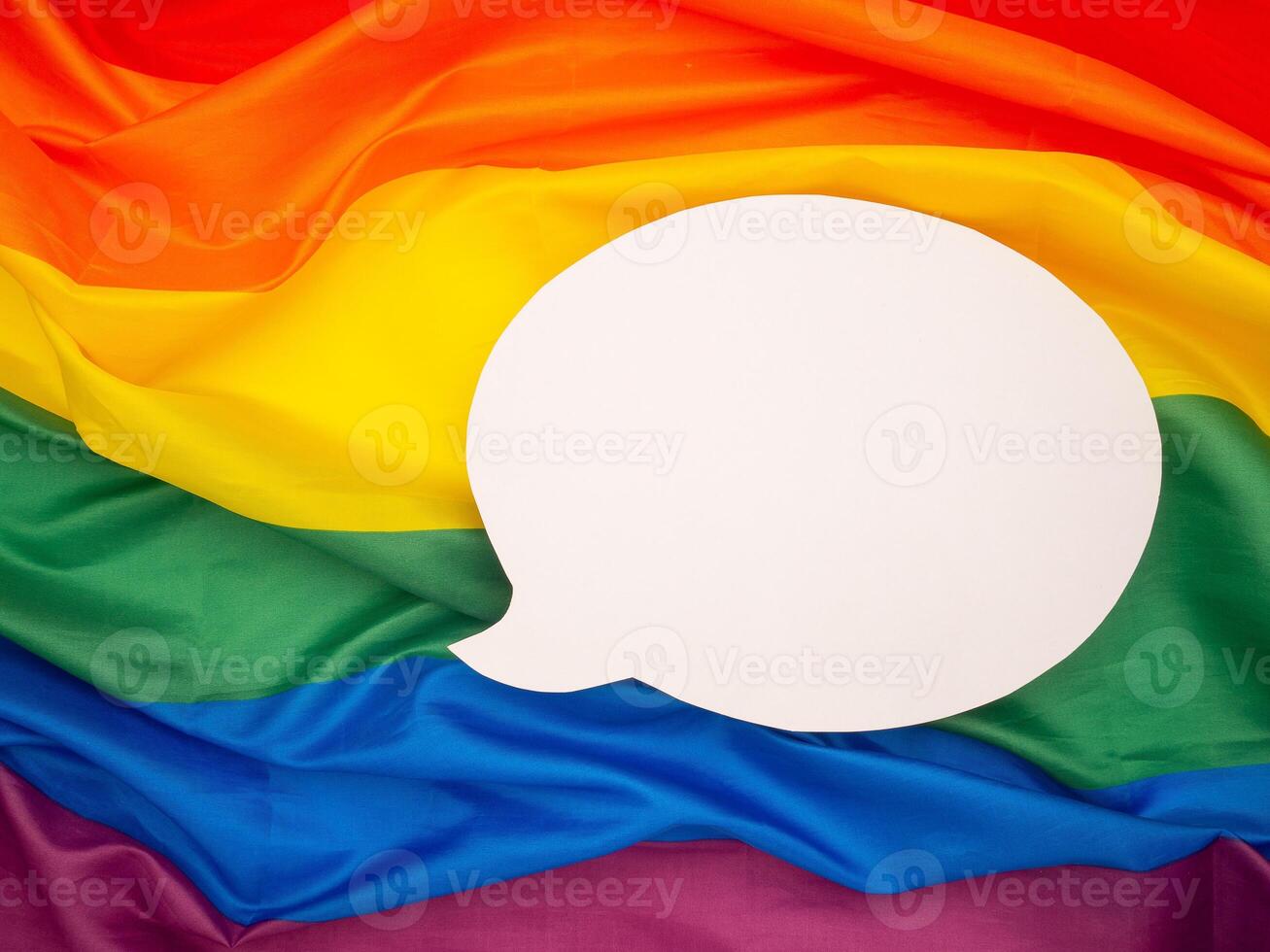Top view of rainbow flag or LGBT flag with a blank white speech bubble photo