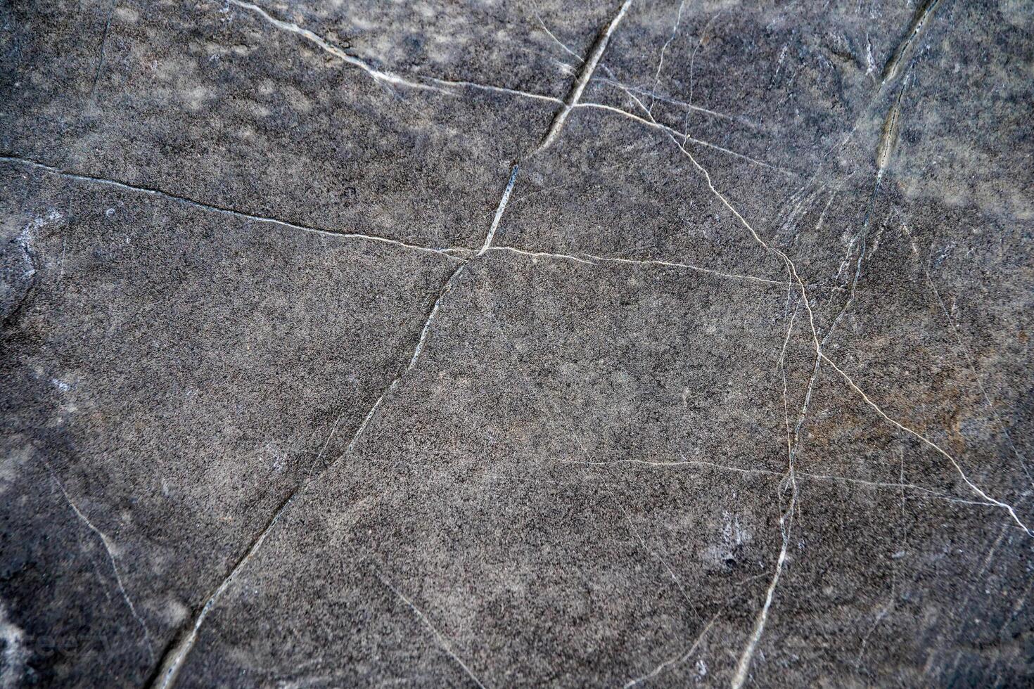 Textured Stone Surface with Natural Cracks and Patterns for Background or Design Elements in Architecture and Interior Design Projects photo