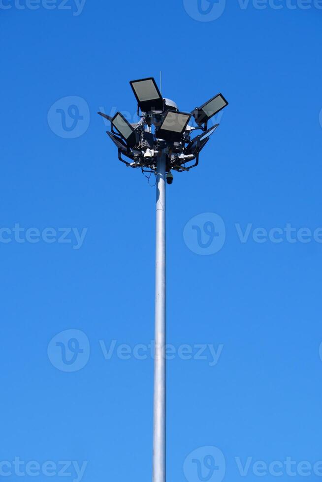 Tall Street Light Pole Against Clear Blue Sky on a Sunny Day Capturing Urban Infrastructure and Minimalist Design photo