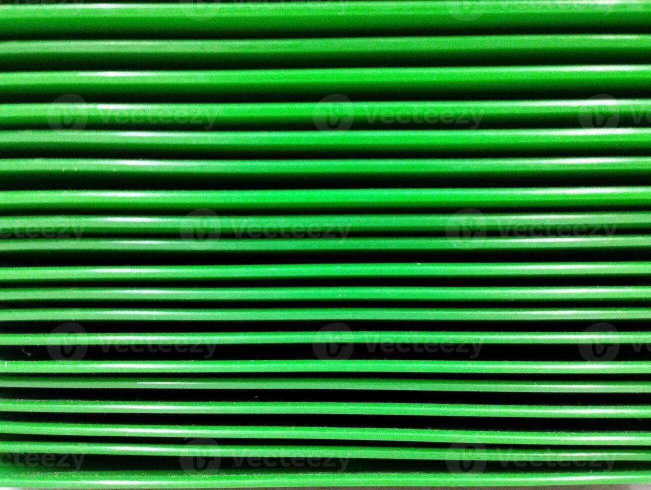 the layer of green vibrant plates color makes a stripped surface horizontal lines photo