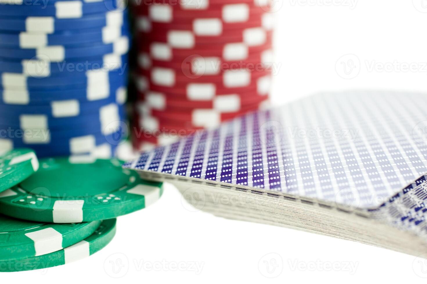 Three color poker chip stacks and cards deck photo