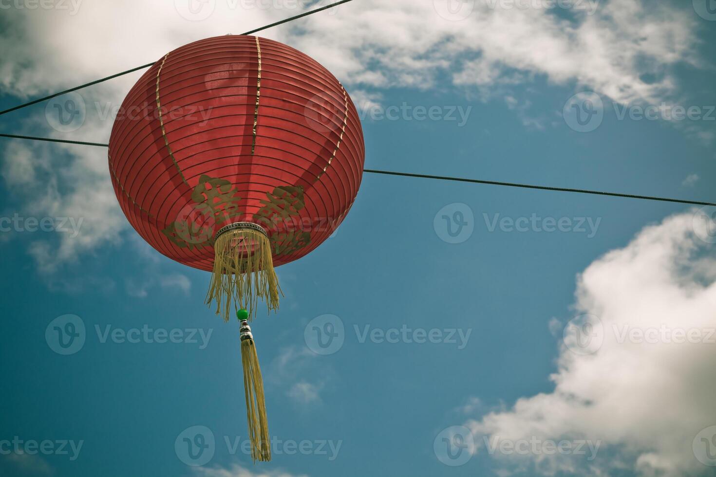 Red Chinese Paper Lantern against a Blue Sky photo