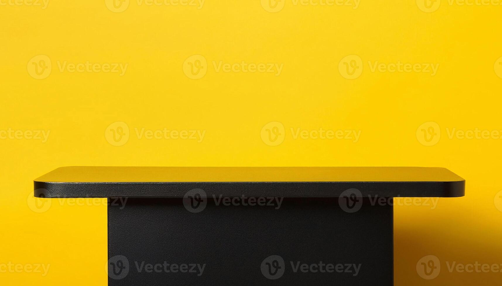 sleek black table with bright yellow background for modern and playful product display setups photo