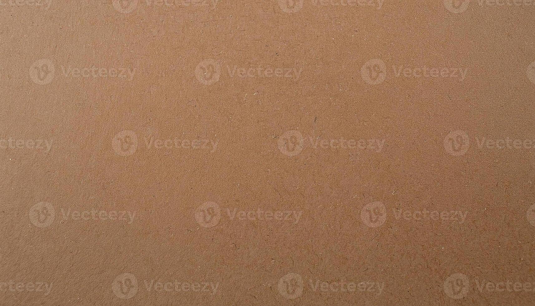 close-up of natural brown kraft paper texture with subtle speckled details and eco-friendly aesthetic for packaging and design photo