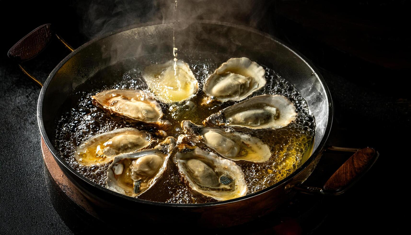 top view of fresh oysters frying in bubbling oil with steam and golden textures in a pan photo