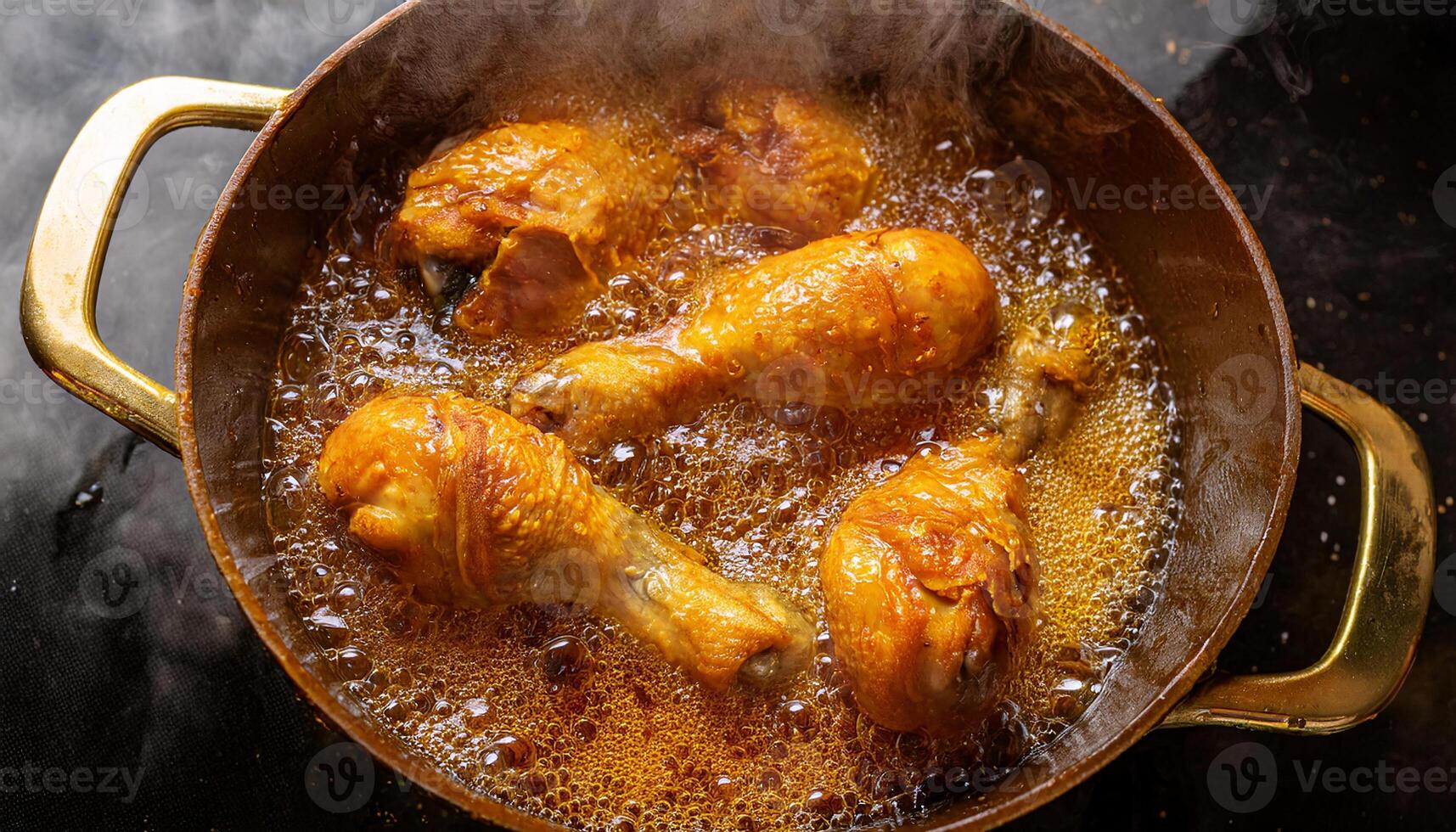 close-up view of chicken drumsticks frying in golden bubbling oil with crispy texture and steam rising photo