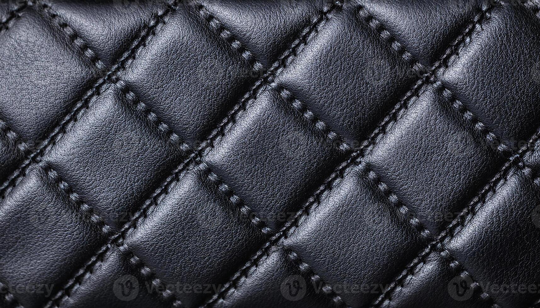 macro view of quilted leather pattern in black with fine stitching, ideal for luxury handbags, upholstery, and premium fashion accessories photo