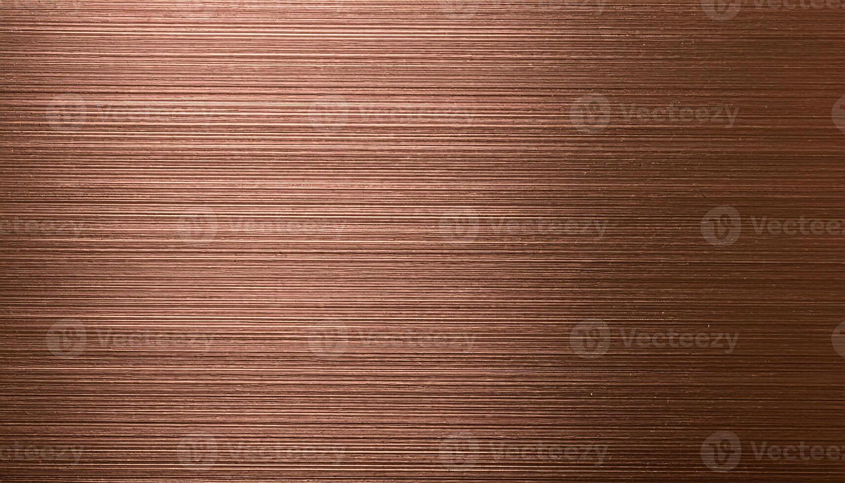 macro view of brushed bronze sheet with horizontal grain and smooth metallic texture photo