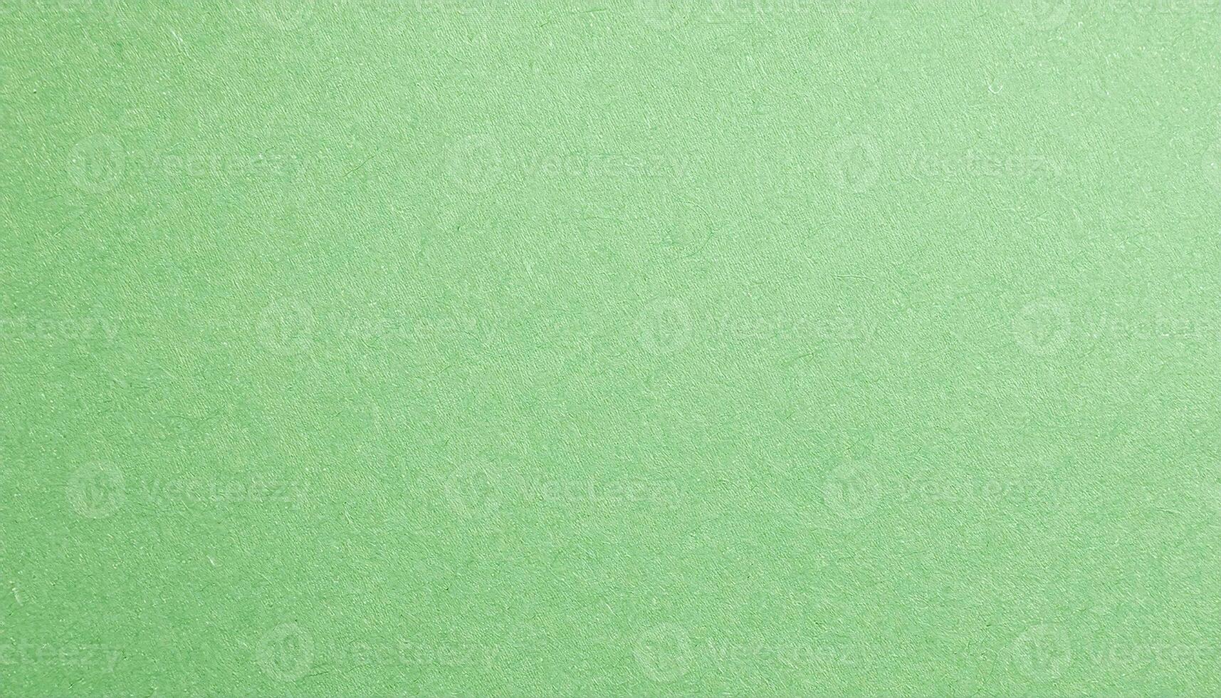 macro view of pale green paper with faintly visible grain texture, ideal for eco-friendly crafts, stationery, and artistic projects photo
